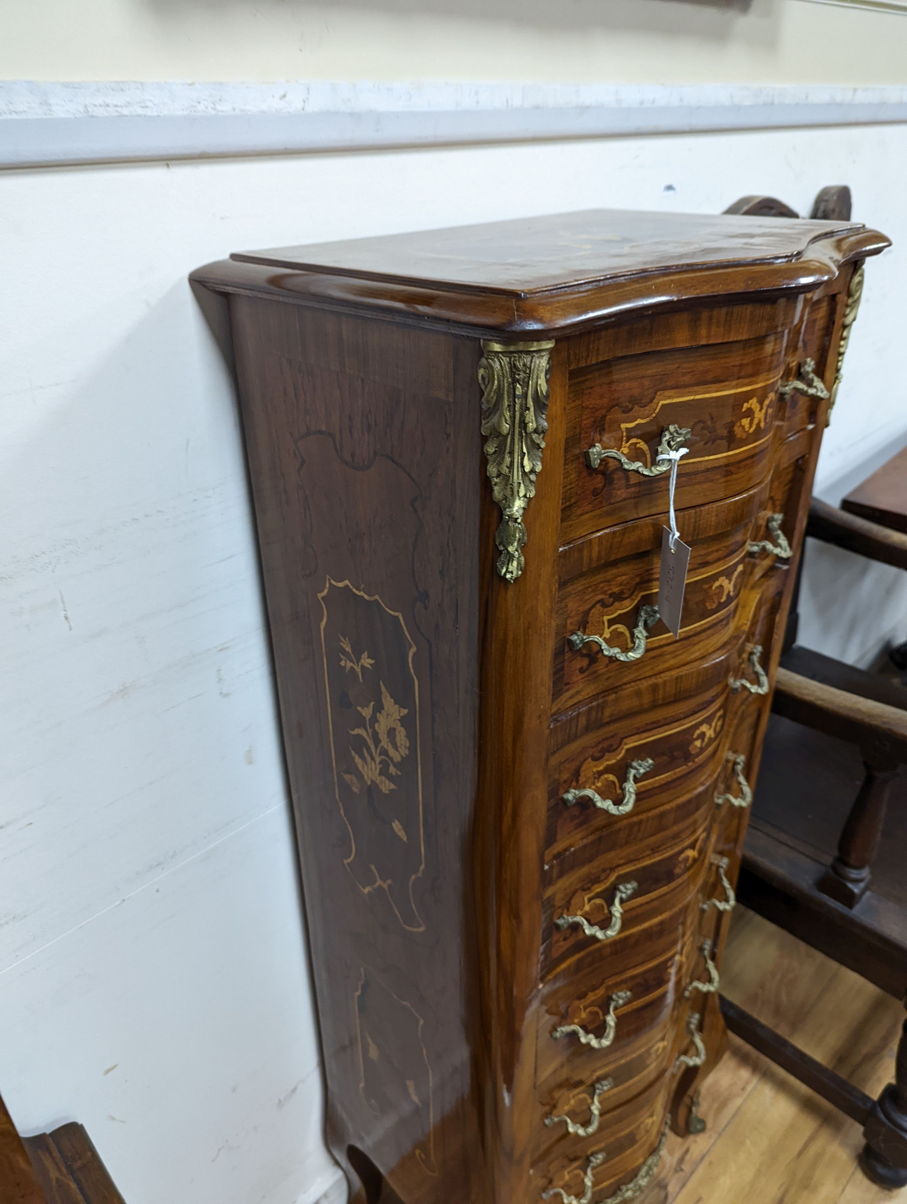 A Louis XV style marquetry inlaid serpentine fronted semanier, fitted seven small drawers, width 47cm, height 122cm